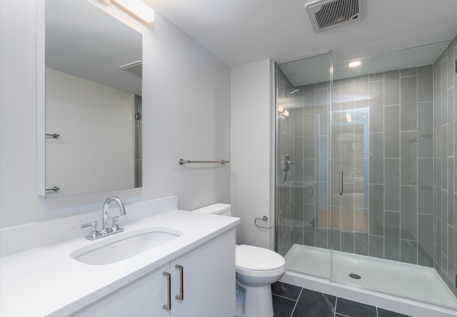 Bathroom with glass walk-in shower and tile surround, no people